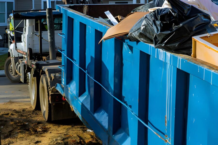 Loading the garbage container old and used construction material in the new building construction work site
